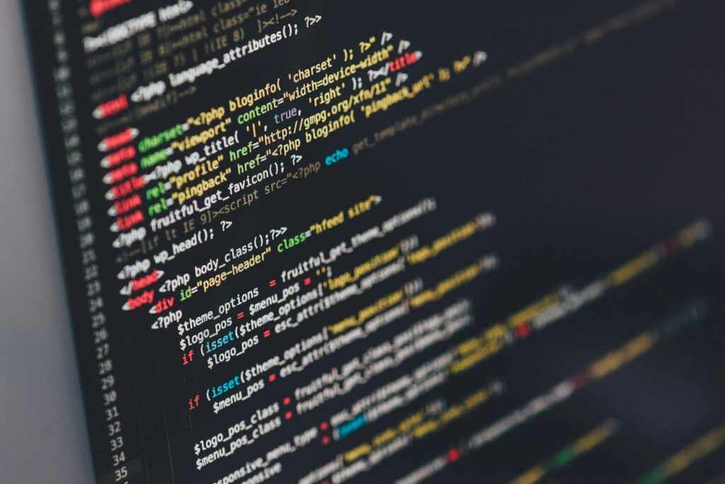 Developer comparing software tools on multiple monitors